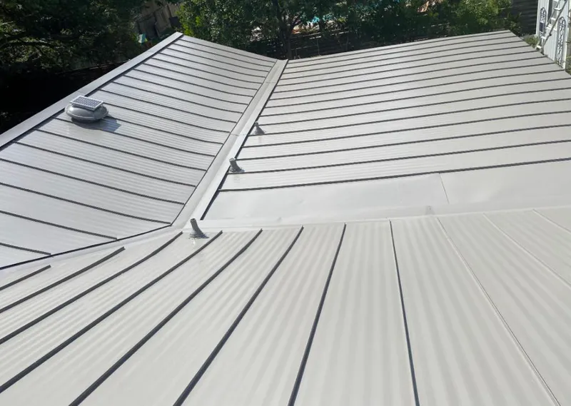Solar attic fan installed on a metal roof for Roof Ventilation in Hermantown